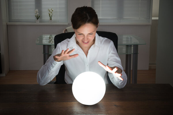 Businesswoman Looking In A Crystal Ball