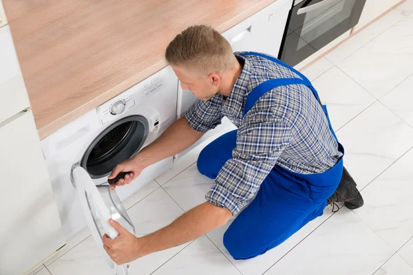 Worker In Overall Fixing Washer — Stock Photo, Image