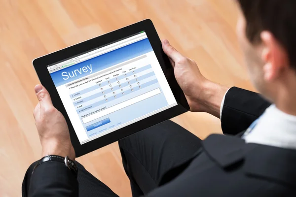 Businessman Looking At Online Survey Form — Stock Photo, Image