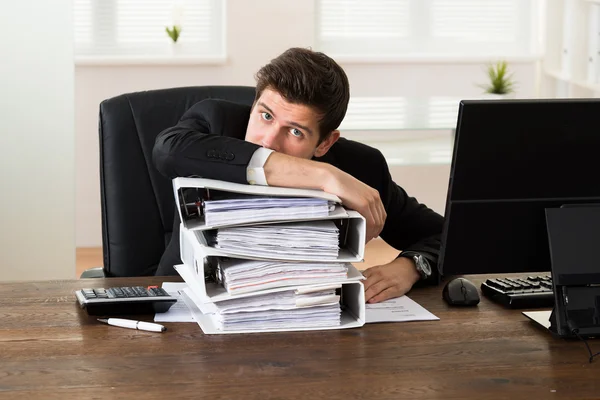 Businessman Leaning On Stack Of Folders — Stock Photo, Image