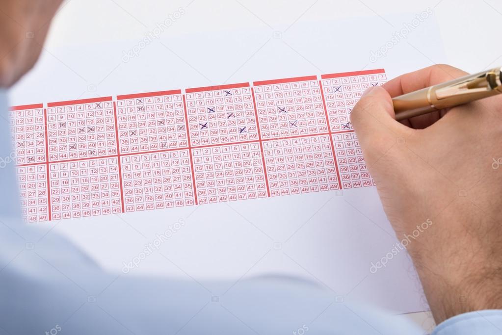Businessperson Marking On Lottery Ticket