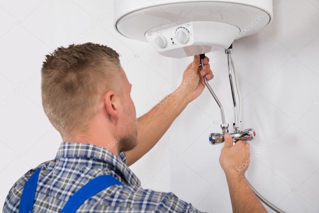 Worker Fixing Electric Boiler