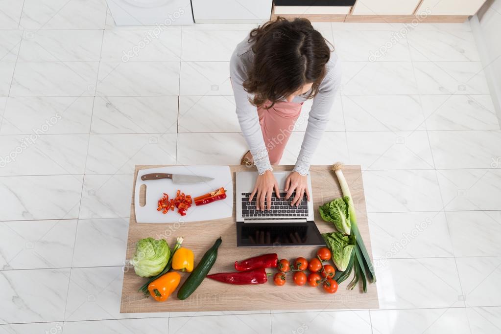 Woman Looking For Recipe On Laptop