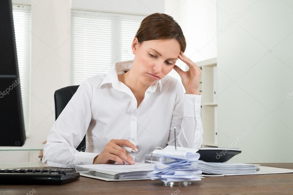 Contemplated Businesswoman Calculating Receipts