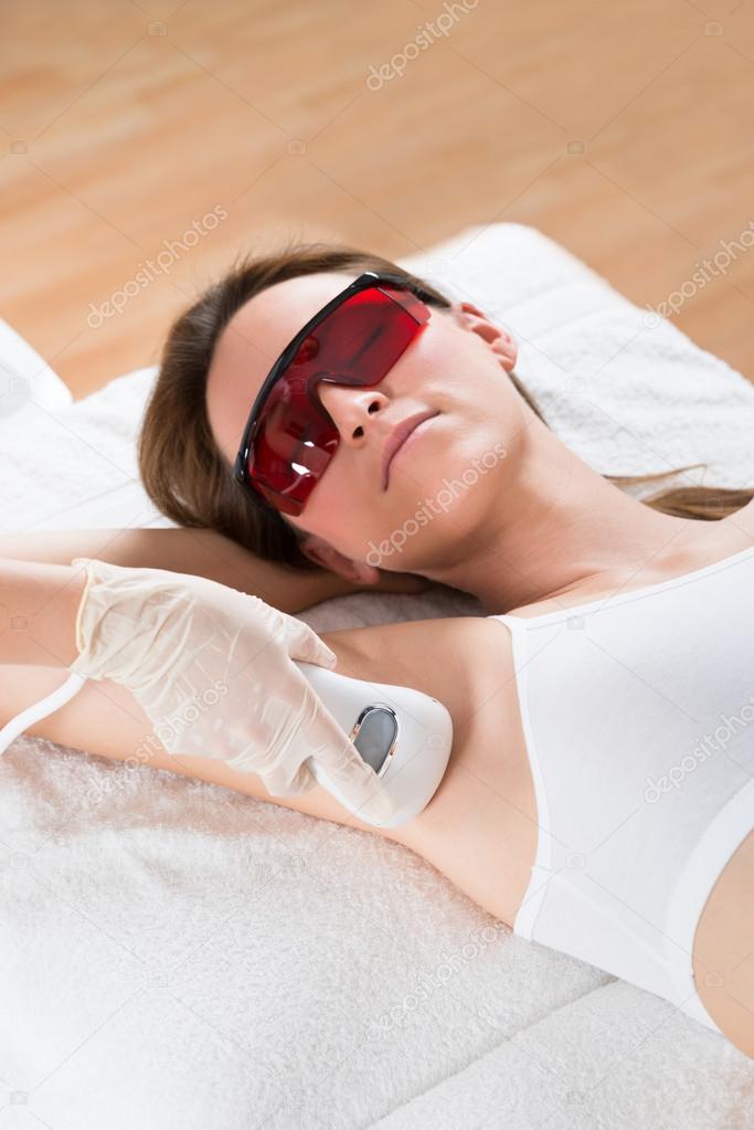 Beautician Removing Hair Of Woman With Epilator