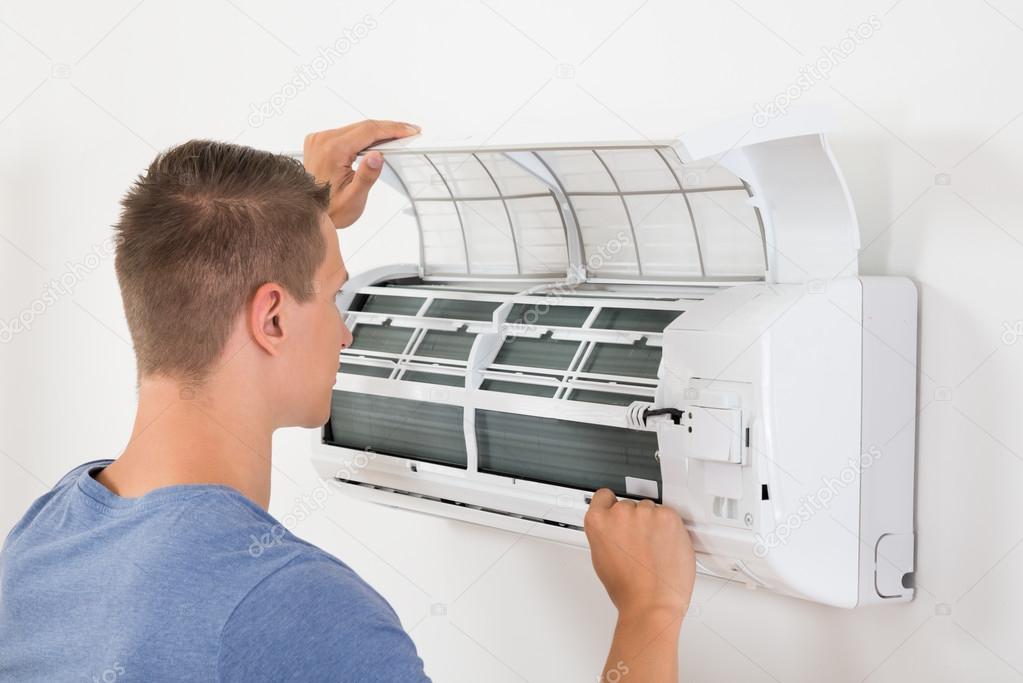 Man Checking Air Conditioner