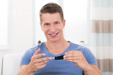 Man Checking Blood Sugar Level clipart