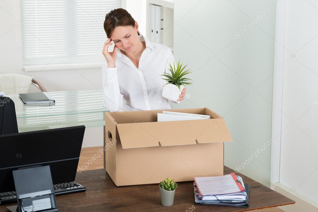 Businesswoman Putting Belongings In Box