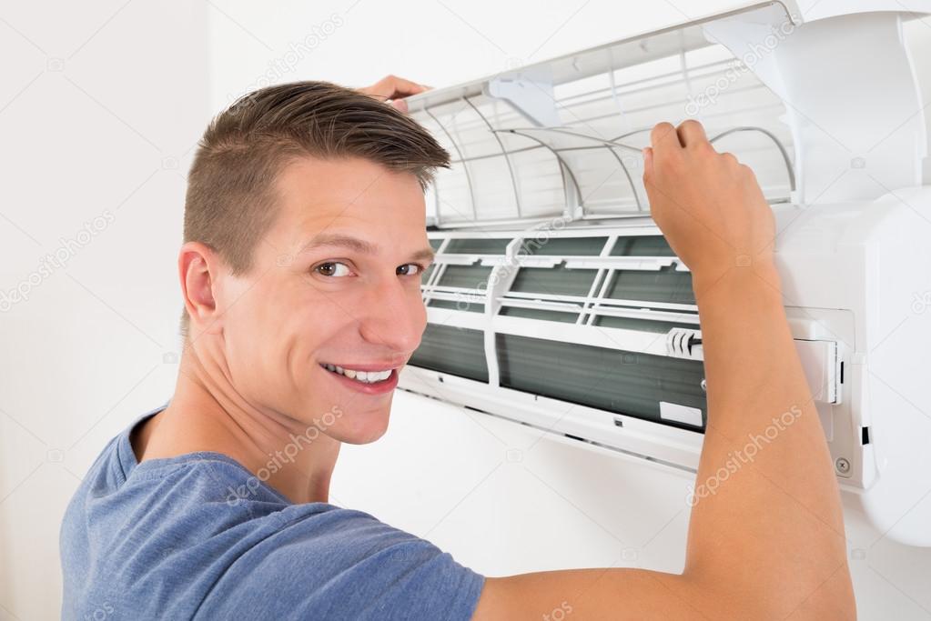 Man Cleaning Air Conditioning System — Stock Photo © AndreyPopov 84502098