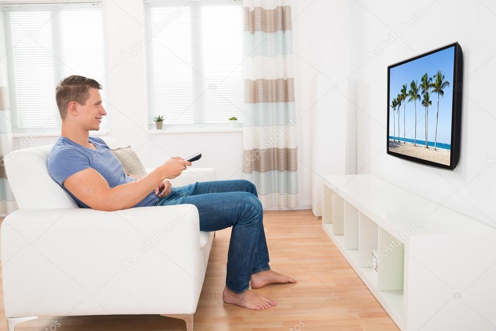 Man On Sofa Watching Television