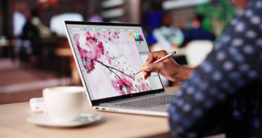 Afrikalı Sanatçı Kafe 'de Dizüstü bilgisayarda Yazdırmak için Grafik Yarattı.