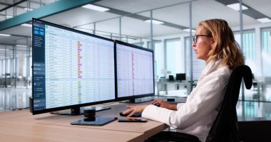 Hospital Doctor Using Spreadsheet For Billing Codes On Desktop