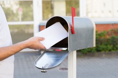 Person Putting Letters In Mailbox clipart
