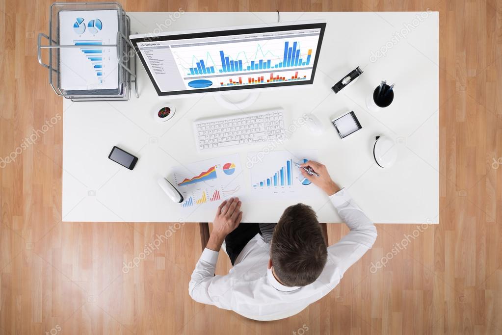 Businessman Analyzing Statistical Graphs