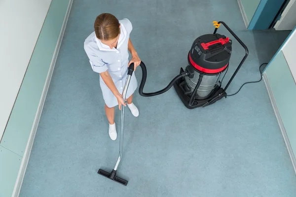 Female Worker Cleaning With Vacuum Cleaner — Stock Photo, Image