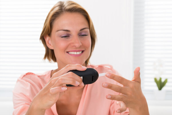 Woman Checking Glucose Level