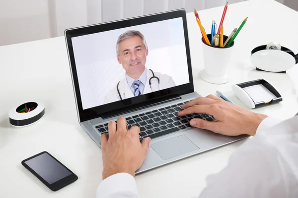 Businessperson Videochatting With Doctor On Laptop — Stock Photo, Image