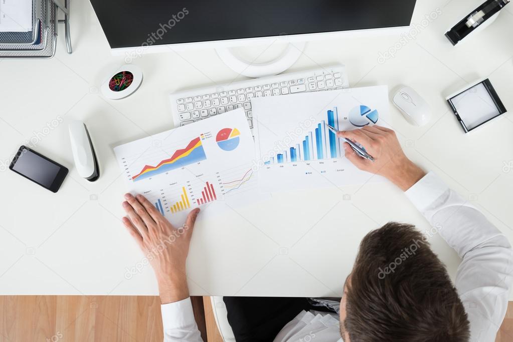 Businessman Analyzing Financial Graphs