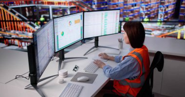 Kadın Depo İşlemcisi Envanter Verimliliğini Yönetmek için Bilgisayar Yazılımı Kullanıyor