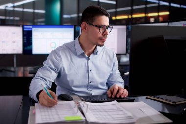 Masaüstündeki Hesap Tablosunu Kullanarak Genç İspanyol Muhasebeci Elektronik Faturaları Hesaplıyor.