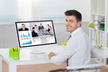 Businessman Videoconferencing On Computer clipart
