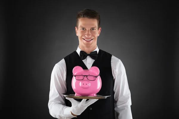 Butler Holding Tray With Piggybank — Stock Photo, Image