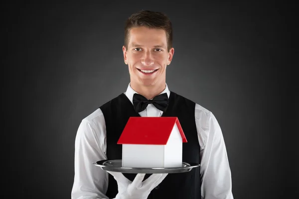 Butler Holding Tray With House Model — Stock Photo, Image