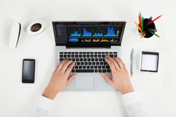 Businessperson Analyzing Graph On Laptop — Stock Photo, Image