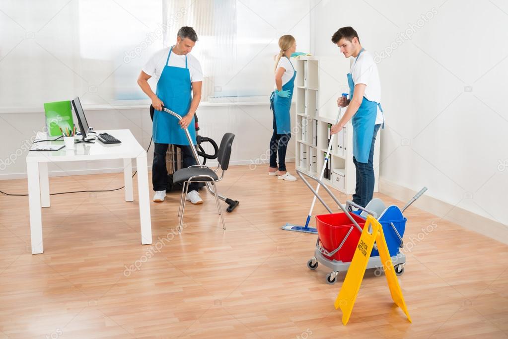 Janitors In Blue Apron Cleaning Office