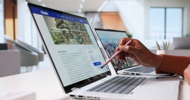 Otel sitesinde tatil için dizüstü bilgisayar kullanan siyah kadın..