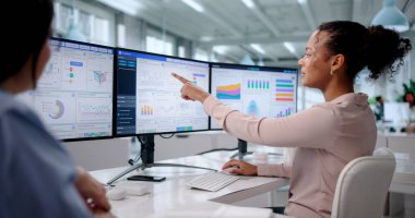 Diverse Business Coach Analyzing Data On Corporate Office Computer Dashboard