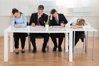 Businesspeople Getting Bored While Working In Office clipart
