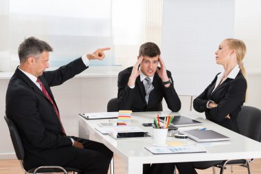 Businessman Arguing With His Two Coworkers clipart
