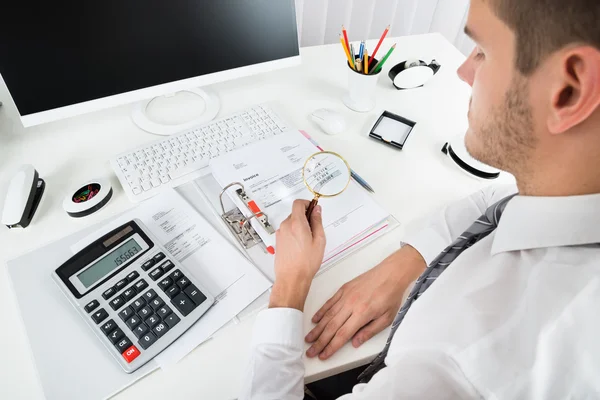 Businessman Checking Invoice With Magnifying Glass — Stock Photo, Image