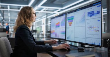 Corporate Woman Studying Multiple Computer Screens In Office, Analyzing Data.