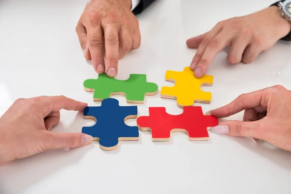 People Assembling Puzzle Pieces — Stock Photo, Image