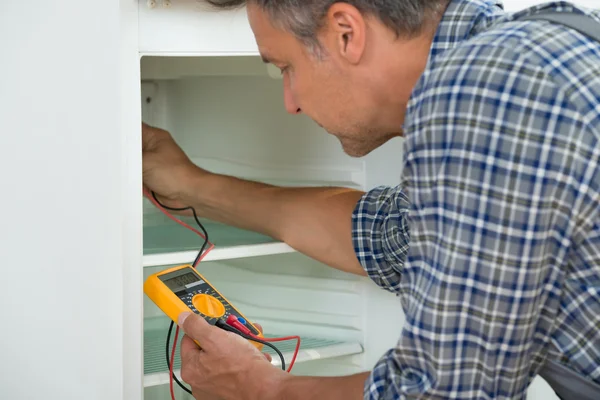 Repairman Checking Fridge With Digital Multimeter — Stock Photo, Image