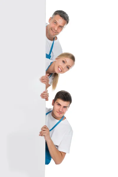 Janitors Looking From Behind The Billboard — Stok Foto