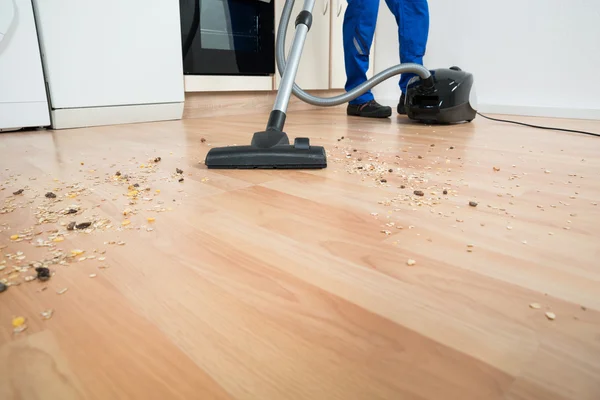 Hausmeister reinigt Boden mit Staubsauger — Stockfoto