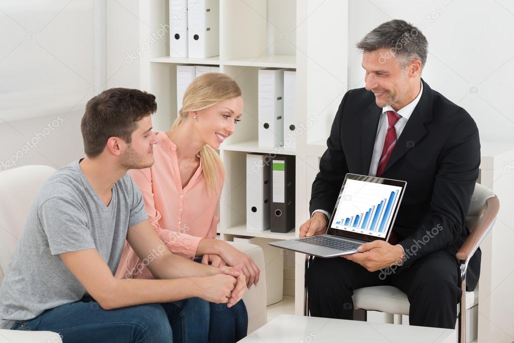 Financial Consultant Showing Graph To Couple