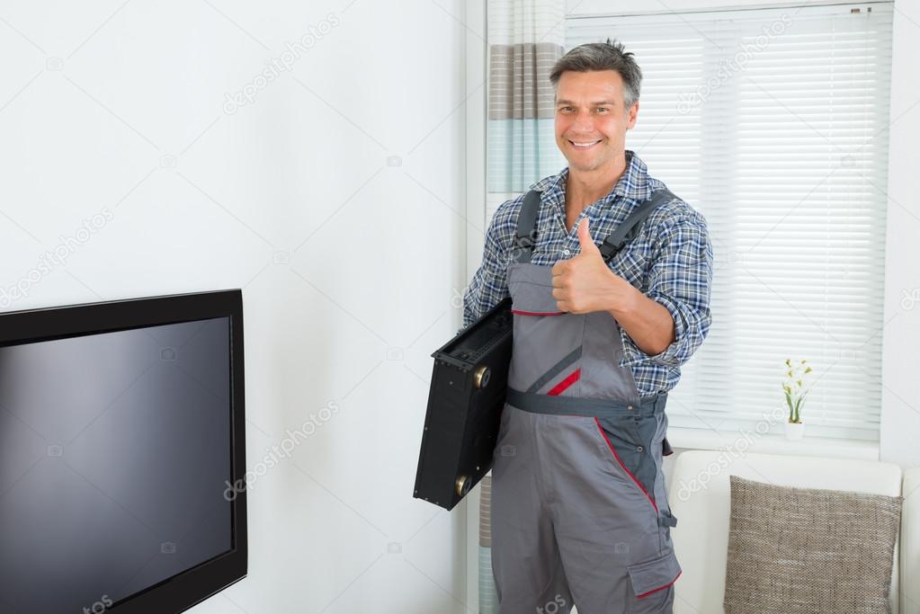 Happy Technician With TV  At Home