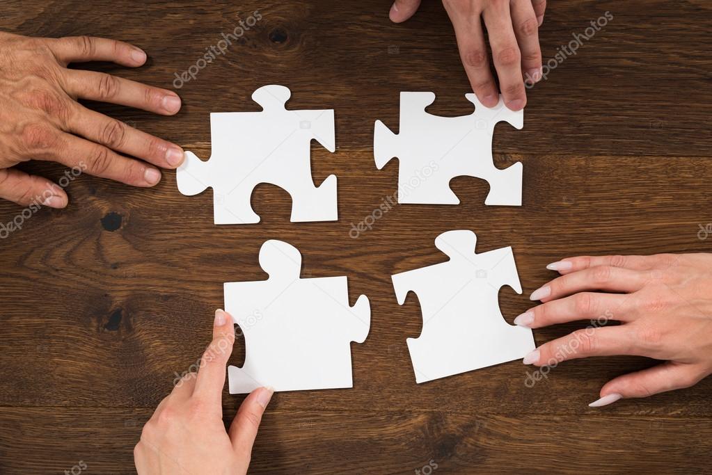 Human Hands Connecting Puzzle Piece
