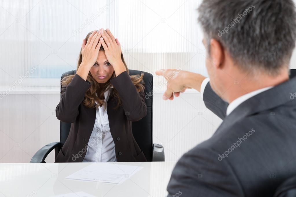 Businessman Pointing To Frustrated Businesswoman