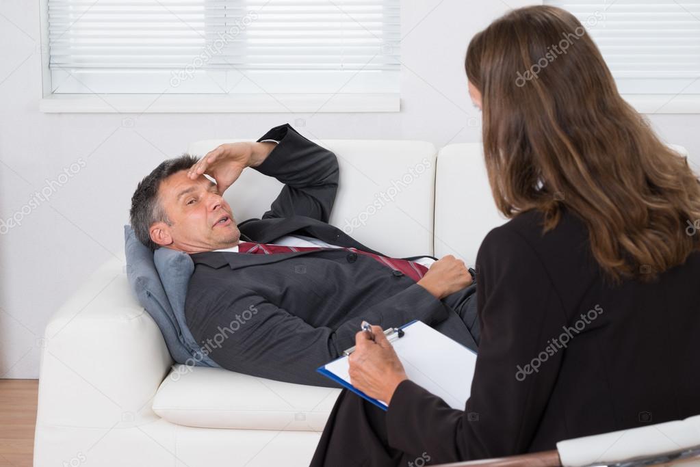 Patient Relaxing In Front Of A Psychiatrist