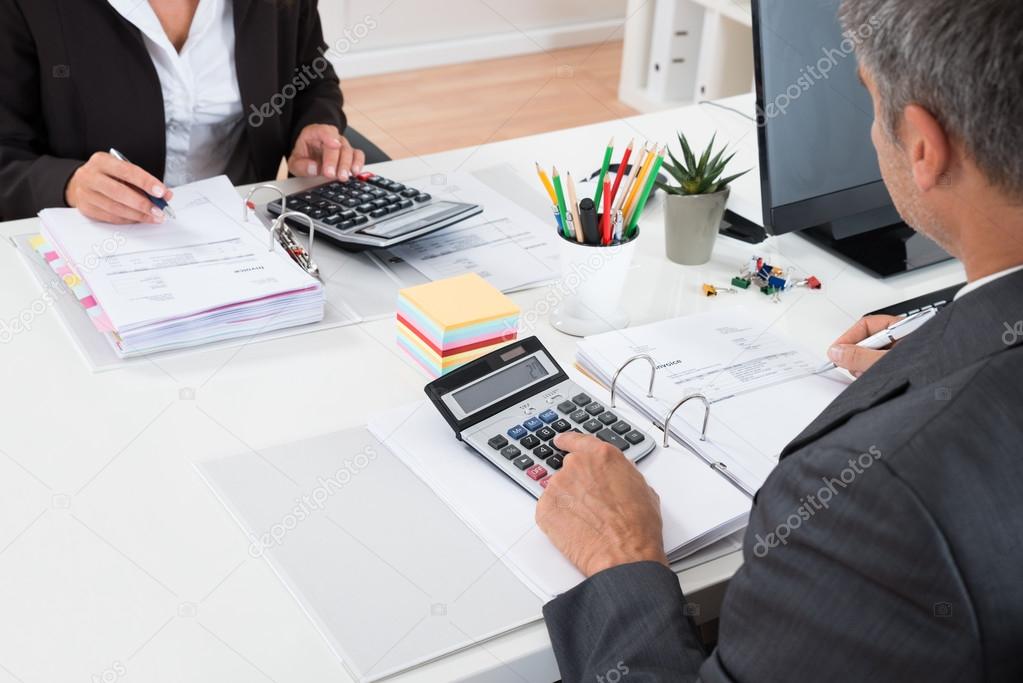 Two Businesspeople Calculating Financial Statement