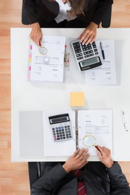 Two Businesspeople Inspecting Financial Expenses