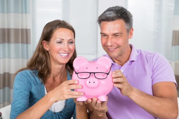 Casal segurando Piggybank — Fotografia de Stock