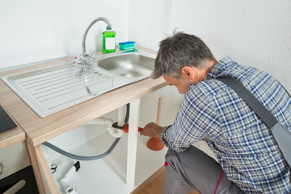 Klempner repariert Spülrohr in Küche — Stockfoto