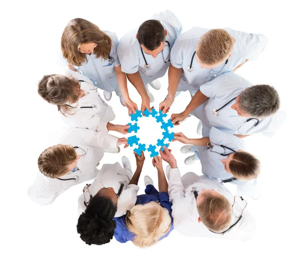 Medical Team Joining Jigsaw Pieces — Stock Photo, Image