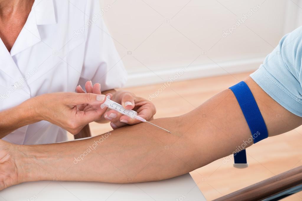 Doctor Injecting Injection To Patient